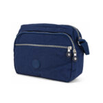 Blue shoulder bag with curved front zip, horizontal zip and circular patch — Polyester fabric, SKU 3352